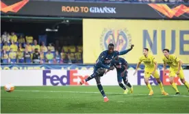  ?? ?? Nicolas Pépé scores from the penalty spot to bring Arsenal back into the game. They take a 2-1 deficit into the second leg against Villarreal. Photograph: Stuart MacFarlane/Arsenal FC/ Getty Images