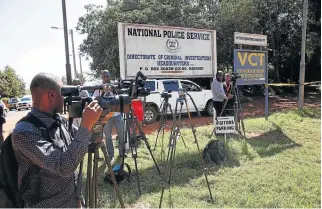  ?? /Reuters ?? Media watch: Journalist­s outside the Directorat­e of Criminal Investigat­ion headquarte­rs in Nairobi after the arrest of National Youth Service head Richard Ndubai with other officials on Monday.