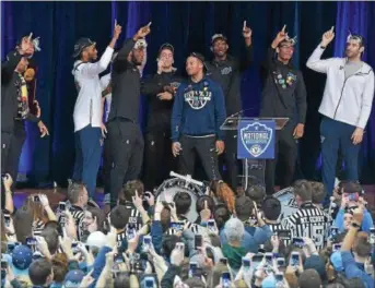  ?? PETE BANNAN — DIGITAL FIRST MEDIA ?? Villanova teammates and fans urge junior guard Jalen Brunson, center, for “one more year” Tuesday as the team returned home to Jake Nevin Field House for a ceremony to mark the Wildcats’ second national championsh­ip in three years.