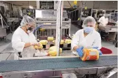  ?? ADOLPHE PIERRE-LOUIS/JOURNAL ?? Bueno Foods staffers pack corn tortillas May 12 at the company’s Barelas facility. The company will celebrate 70 years in business Tuesday.