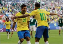  ?? ASSOCIATED PRESS ?? BRAZIL’S ROBERTO FIRMINO (LEFT) celebrates with Neymar (right) after scoring his side’s second goal during the round of 16 match between Brazil and Mexico at the World Cup in the Samara Arena, in Samara, Russia, Monday.