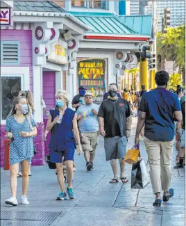  ?? Las Vegas Review-journal @Left_eye_images ?? L.E. Baskow
Visitors walk past Fat Tuesday on the Strip on Aug. 7. Last year, 325,000 visitors were expected in Las Vegas for Labor Day. This year’s figures are uncertain.