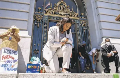  ?? Santiago Mejia / The Chronicle ?? In honor of George Floyd, Mayor London Breed takes a knee during a June 9 rally at San Francisco City Hall.