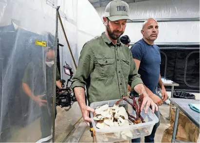  ?? PHOTOS BY NIRMALENDU MAJUMDAR/AMES TRIBUNE ?? Tanner Faaborg shows mushrooms he harvested while shooting a documentar­y at 1100 Farm in Radcliffe on Tuesday.