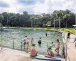  ?? PATRICK CONNOLLY/ORLANDO SENTINEL ?? Visitors enjoy the spring head and natural swimming area at De Leon Springs State Park in 2019.