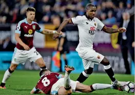  ?? — AFP ?? Watford striker Odion Ighalo (right) and Dean Marney of Burnley (centre) vie for the ball in their English Premier League match at Turf Moor in Burnley, England, on Monday. The hosts won 2-0.