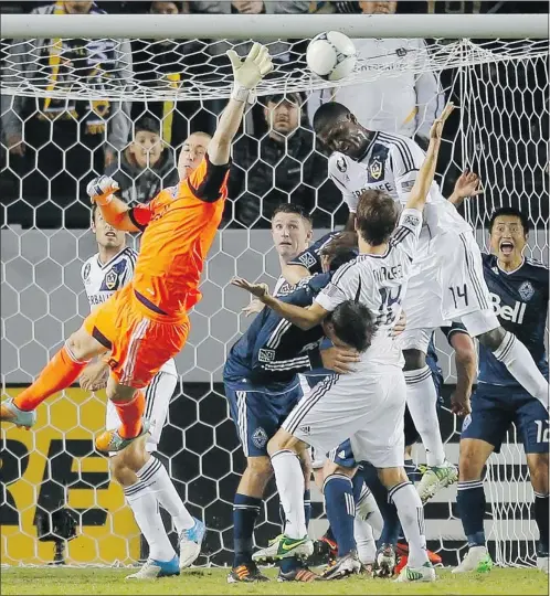  ?? — AP ?? Goalkeeper Brad Knighton, left, and the Vancouver Whitecaps kept this Galaxy attempt out of the net.