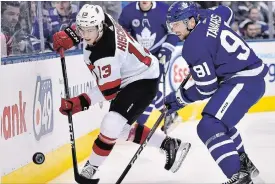  ?? FRANK GUNN THE CANADIAN PRESS ?? Leafs centre John Tavares challenges Devils’ Nico Hischierin Toronto on Friday.