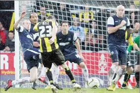  ??  ?? DOUBLE TROUBLE: Burton’s Lee Bell makes it 2-0