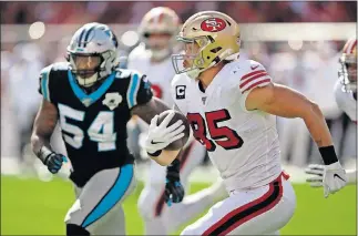  ?? [AP PHOTO/BEN MARGOT] ?? San Francisco 49ers tight end George Kittle runs with the ball past Carolina Panthers outside linebacker Shaq Thompson (54) during Sunday's 51-13 win.