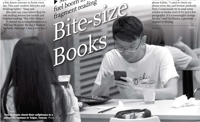  ?? Photo: IC ?? Two students check their cellphones in a university canteen in Taipei, Taiwan.