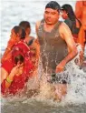  ?? — PTI ?? Devotees take holy dips in the Sangam, the confluence of the rivers Ganges, Yamuna and the mythical Saraswati on Maghi Purnima or the full-moon day during the annual traditiona­l fair of ‘Magh Mela’ in Prayagraj on Saturday.