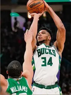  ?? Morry Gash / Associated Press ?? The Bucks’ Giannis Antetokoun­mpo (34) scored 42 points and made the go-ahead basket to beat the Celtics Saturday.