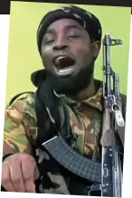  ??  ?? Humiliated: The hostages mocked by Shekau, above