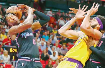  ?? AP ?? Action from the match between Miami Heat and Los Angeles Lakers during the first half of their NBA game in Miami on Sunday. Lakers won 113-97. —