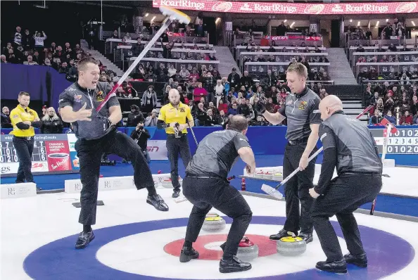  ?? JUSTIN TANG/THE CANADIAN PRESS ?? Ben Hebert, left, throws his broom as he celebrates with the members of team Koe after beating team McEwen in the Roar of the Rings final on Sunday.