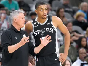  ?? (AP photo/Darren Abate) ?? San Antonio Spurs assistant coach Brett Brown, left, talks with Spurs forward Keldon Johnson Sunday during a basketball game against the Phoenix Suns in San Antonio.