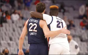  ?? The Associated Press ?? FRIENDLY GAME: Virginia center Francisco Caffaro (22) and Gonzaga center Oumar Ballo (21) walk off the court together following Saturday’s game in Fort Worth, Texas.