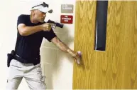  ?? LUIS SANTANA Tampa Bay Times ?? Former law enforcemen­t officer Scott Bowlin prepares to enter a classroom during active shooter drills put on by the Pasco County Sheriff as training for the Guardian program.