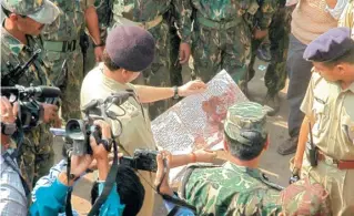  ?? FILE PHOTO ?? A police officer looks at a bloodstain­ed pamphlet left by the Naxals after the jailbreak.