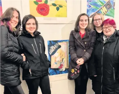  ??  ?? Great effort Ella Reilly, third from right, takes a look at her still life produced with block paint