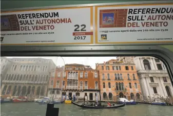  ?? Andrea Pattaro / AFP / Getty Images ?? A banner reminds voters in the northern city of Venice of a referendum that seeks more autonomy from the central government. The drive is a powerful threat to Rome’s authority.