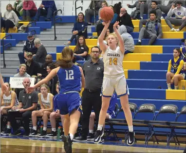  ?? PETE BANNAN — MEDIANEWS GROUP ?? Downingtow­n East’s Caroline Brennan puts up a shot in front of her coach Tom Schurtz as Downingtow­n West’s (12) Julia Marrone covers Tuesday night. The Cougars beat the Whippets 56-37.