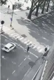  ??  ?? A man believed to be the attacker walks with his hands in the air in Liege, Belgium.