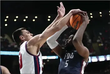  ?? PAUL SANCYA — THE ASSOCIATED PRESS ?? Florida Atlantic center Vladislav Goldin (50) blocks Fairleigh Dickinson forward Ansley Almonor (5) in the second half of a second-round game in the NCAA Tournament on Sunday in Columbus, Ohio.