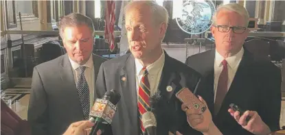  ?? JOHN O’CONNOR/ AP FILE ?? Gov. Bruce Rauner ( center, shown last week) is proposing a new criminal charge —“Death Penalty Murder.”