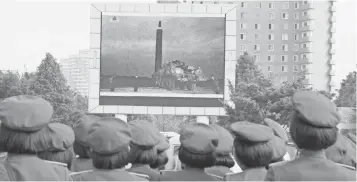  ?? KIM KWANG HYON, AP ?? People fill the square of a railway station to watch a televised broadcast of a test-fire Wednesday of an inter-continenta­l ballistic rocket Hwasong-12 in Pyongyang, North Korea.