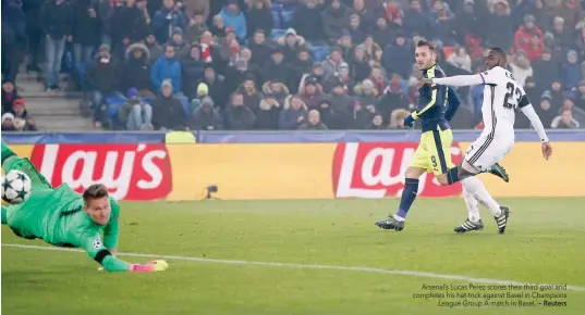  ?? — Reuters ?? Arsenal’s Lucas Perez scores their third goal and completes his hat-trick against Basel in Champions League Group A match in Basel.