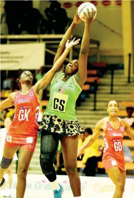  ??  ?? England’s goalkeeper Ama Agbeze (left) tries her best to intercept a pass to Jamaica’s Jhaniele Fowler, while goal defence Layla Guscoth looks on during the third and final Lasco Sunshine Series game between Jamaica and England at the National Indoor Sports Centre on October 15, 2018.