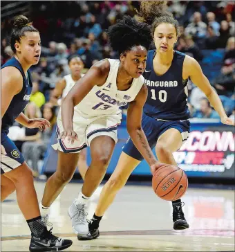  ?? SEAN D. ELLIOT/THE DAY ?? UConn’s Christyn Williams (13) dribbles between Vanguard defenders Alondra Jimenez (5, left) and Treasure Robinson (10) during Sunday’s exhibition game at Gampel Pavilion. UConn won 96-30.