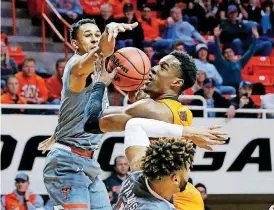  ?? [AP PHOTO] ?? Oklahoma State forward Cameron McGriff, center, drives to the basket between Texas Tech guard Zhaire Smith, left, and guard Brandone Francis (1) during the Cowboys 79-71 win over the Red Raiders Wednesday in Stillwater.