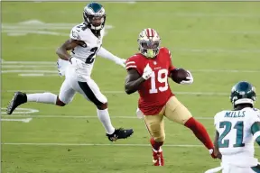  ?? Ezra Shaw / Getty Images /TNS ?? San Francisco 49ers wide receiver Deebo Samuel (19) picks up yardage against the Philadelph­ia Eagles at Levi’s Stadium in Santa Clara on Oct. 4.