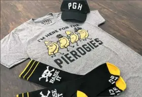  ??  ?? Pittsburgh- and Pirates-themed apparel by Steel City, Downtown.