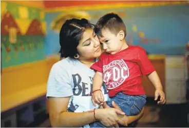  ?? JOSIE LEPE/STAFF PHOTOS ?? Isabel Lopez, 18, holds her 19-month-old son, Elias, for a portrait at the Mayfair Community Center in San Jose. Teen Success has been a godsend, Lopez said. “They teach you how to set your own goals and to follow through and not drop out of school.”