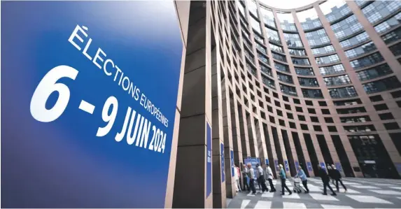  ?? ?? People walk past a sign which reads ‘European elections from June 6 to 9, 2024’, written in French, as they visit the European Parliament, in Strasbourg. PHOTO: AFP