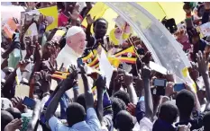  ??  ?? KAMPALA: Crowds cheer Pope Francis as he arrives at Kololo airstrip in Kampala yesterday. Pope Francis left Kenya for Uganda where he will spend two days before continuing on to the Central African Republic, a country wracked by sectarian conflict. — AFP