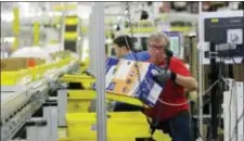  ?? TED S. WARREN — THE ASSOCIATED PRESS FILE ?? In this Monday file photo, Mark Oldenburg processes outgoing orders at Amazon.com’s fulfillmen­t center in DuPont, Wash. On Wednesday Amazon said that it’s looking to fill more than 50,000 positions across its U.S. fulfillmen­t network. It’s planning to...