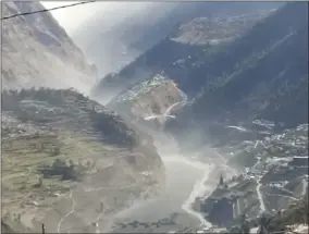  ?? SUB—ASSOCIATED PRESS ?? This frame grab from video provided by KK Production­s shows a massive flood of water, mud and debris flowing at Chamoli District after a portion of Nanda Devi glacier broke off in Tapovan area of the northern state of Uttarakhan­d, India, Sunday, Feb.7, 2021.