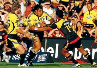  ??  ?? Ma’a Nonu, playing on the wing for the Hurricanes, tries to bump off the tackle of Lelia Masaga in 2007, the last time the Canes beat the Chiefs in Hamilton.