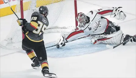  ?? TONI L. SANDYS
THE WASHINGTON POST ?? Capitals goalie Braden Holtby stops a hard shot by diving with his stick out, in what looked like a sure goal, by Golden Knights’ Alex Tuch.