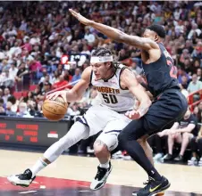  ?? — AFP photo ?? Aaron Gordon of the Denver Nuggets drives against Haywood Highsmith of the Miami Heat.