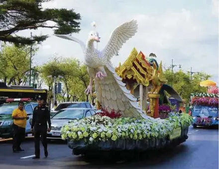  ??  ?? A policeman escorting a Songkran parade in Pathum Wan district, Thailand, in 2019.