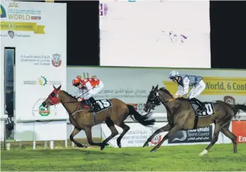  ?? Victor Besa / The National ?? RB Money to Burn, left, with Patrick Cosgrave on board, took a good lead in yesterday’s Abu Dhabi Championsh­ip before getting tired, but the filly managed to hold her own