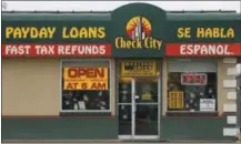  ?? LEAH HOGSTEN - THE ASSOCIATED PRESS ?? This undated photo shows a sign for Check City, which offers payday loans, in Salt Lake City. Americans take out roughly $50 billion in payday loans a year, each racking up hundreds of dollars in fees and interest.