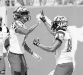  ?? TIM WARNER/GETTY IMAGES ?? Maryland’s Taivon Jacobs, left, and Jacquille Veii celebrate during the Terps’ win at No. 23 Texas Saturday.