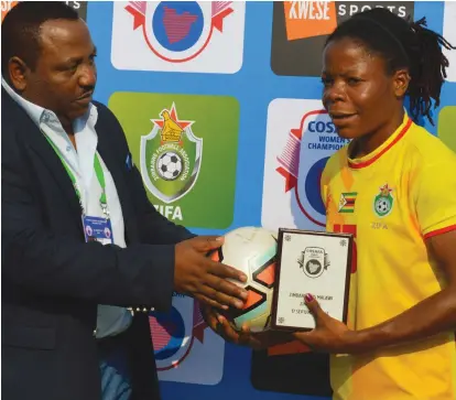  ??  ?? Rutendo Makore receives her player of the match award from Zifa vice president Omega Sibanda for her performanc­e during the Zimbabwe vs Malawi game yesterday. — Pic By Dennis Mudzamiri